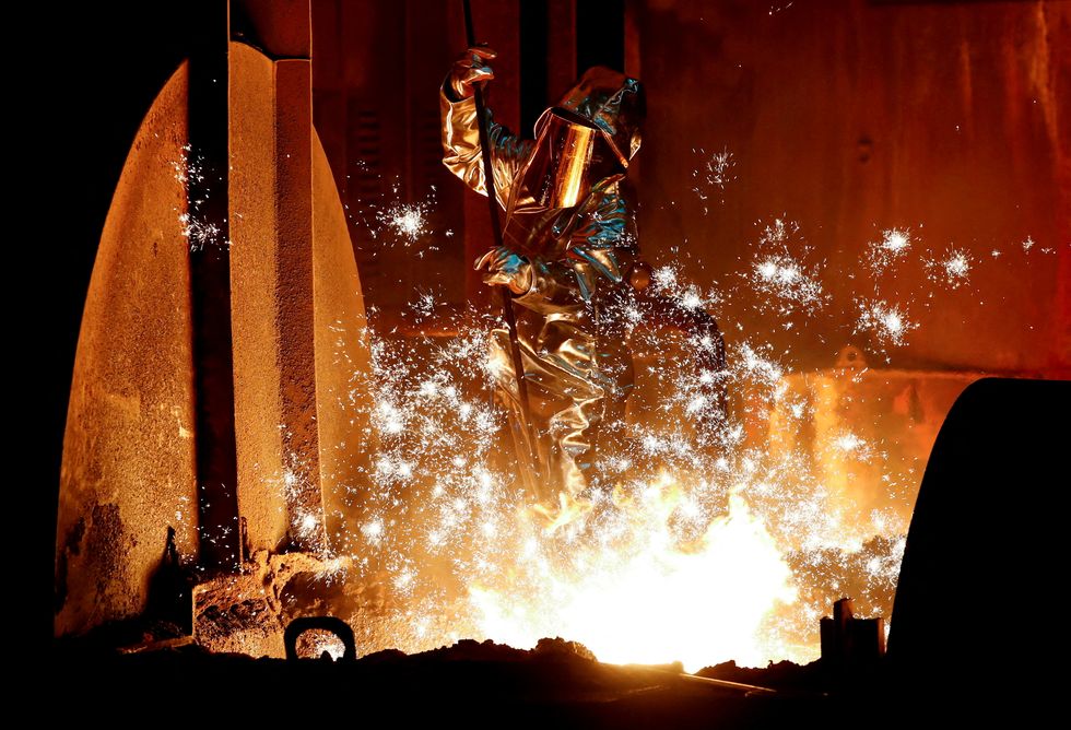 FILE PHOTO: A steel worker for Germany's industrial conglomerate ThyssenKrupp AG takes a sample of raw iron from a blast furnace at Germany's largest steel factory in Duisburg, Germany, January 28, 2019. REUTERS/Wolfgang Rattay/File Photo