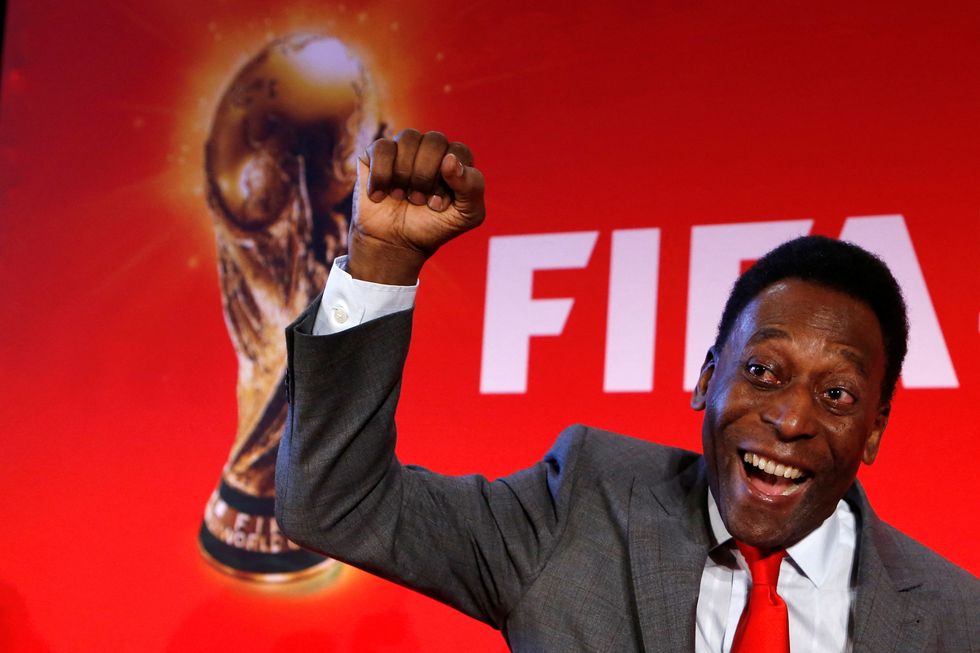 FILE PHOTO: Brazilian soccer legend Pele reacts as he poses after a news conference to present the FIFA World Cup global %22Trophy Tour%22 in Paris March 10, 2014. The 2014 World Cup will be held in Brazil from June 12 through July 13. REUTERS/Gonzalo Fuentes/File Photo