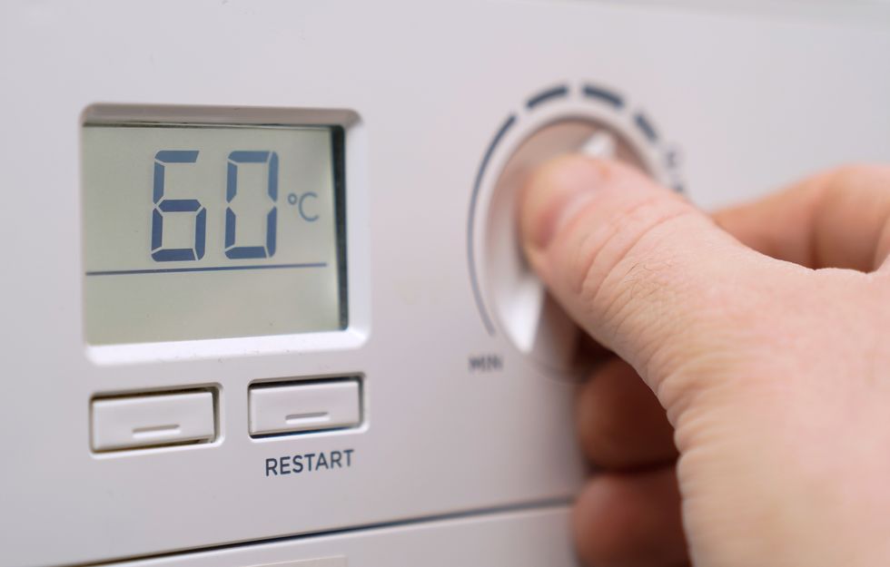 File photo dated 03/02/22/ of a homeowner turning down the temperature of a gas boiler, as headteachers are expecting huge increases in their school energy bills, new polling has revealed, with some schools cutting the number of teaching hours to save money.