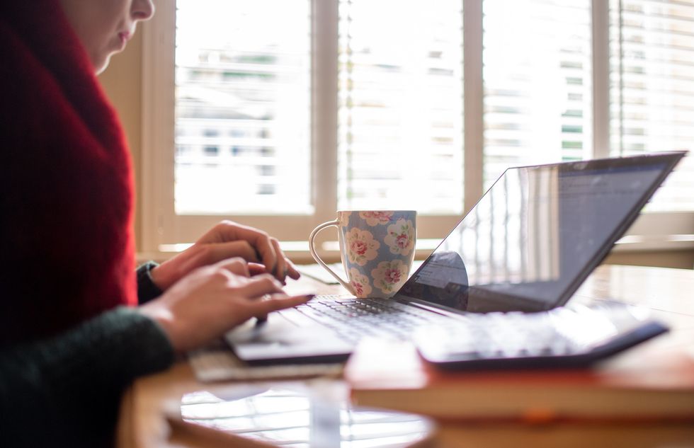 File photo dated 04/03/20 of a woman using a laptop on a dining room table set up as a remote office to work from home. Home working is here to stay and the end of the five-day-a-week office commute will change the shape of cities dramatically, according to former Bank of England deputy governor Sir Charlie Bean. Issue date: Monday March 29, 2021.