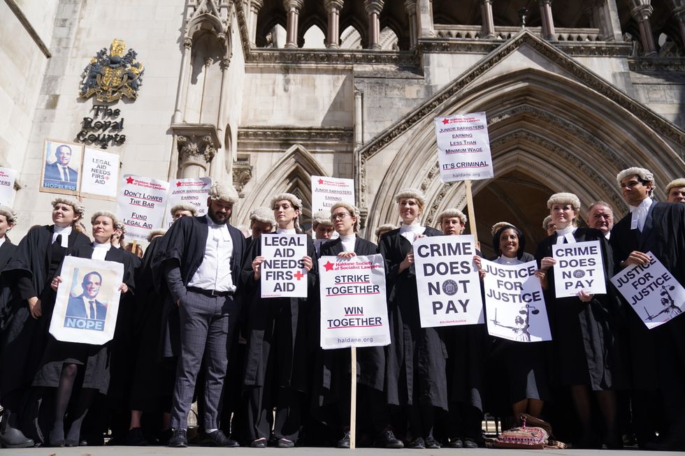 File photo dated 04/07/22 of criminal defence barristers outside the Royal Courts of Justice in London supporting the ongoing Criminal Bar Association (CBA) action over Government set fees for legal aid advocacy work. Barristers are voting on whether to end strike action after a pay offer from the Government. A ballot for Criminal Bar Association (CBA) members opened on Tuesday evening and closes at midnight on Sunday. Issue date: Sunday October 9, 2022.