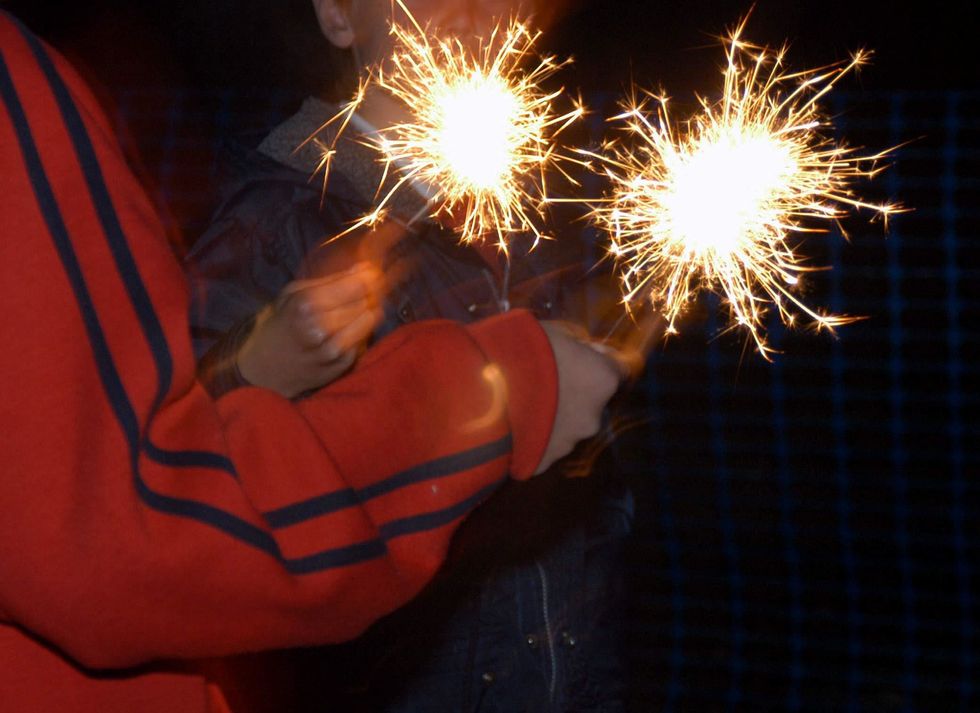 File photo dated 05/11/03 of children playing with sparklers as The Fire and Rescue Service has urged the public to be aware of additional risks during Halloween celebrations. It has urged anyone using fireworks, sparklers or candles to follow its fire safety advice to keep themselves, their family and friends safe. Last Halloween the Northern Ireland Fire and Rescue Service (NIFRS) was called to 90 incidents, a drop from 100 calls in the same 24-hour period in 2020. Issue date: Monday October 24, 2022.
