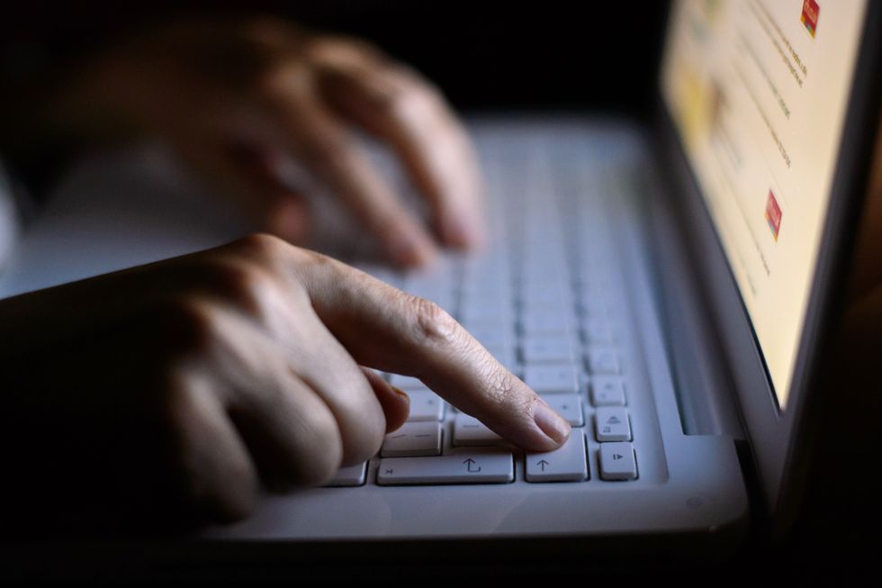 File photo dated 06/08/13 of a woman using a laptop. Cyber attacks have doubled in the last year, the director of the Governments intelligence agency has revealed. Issue date: Monday October 25, 2021.