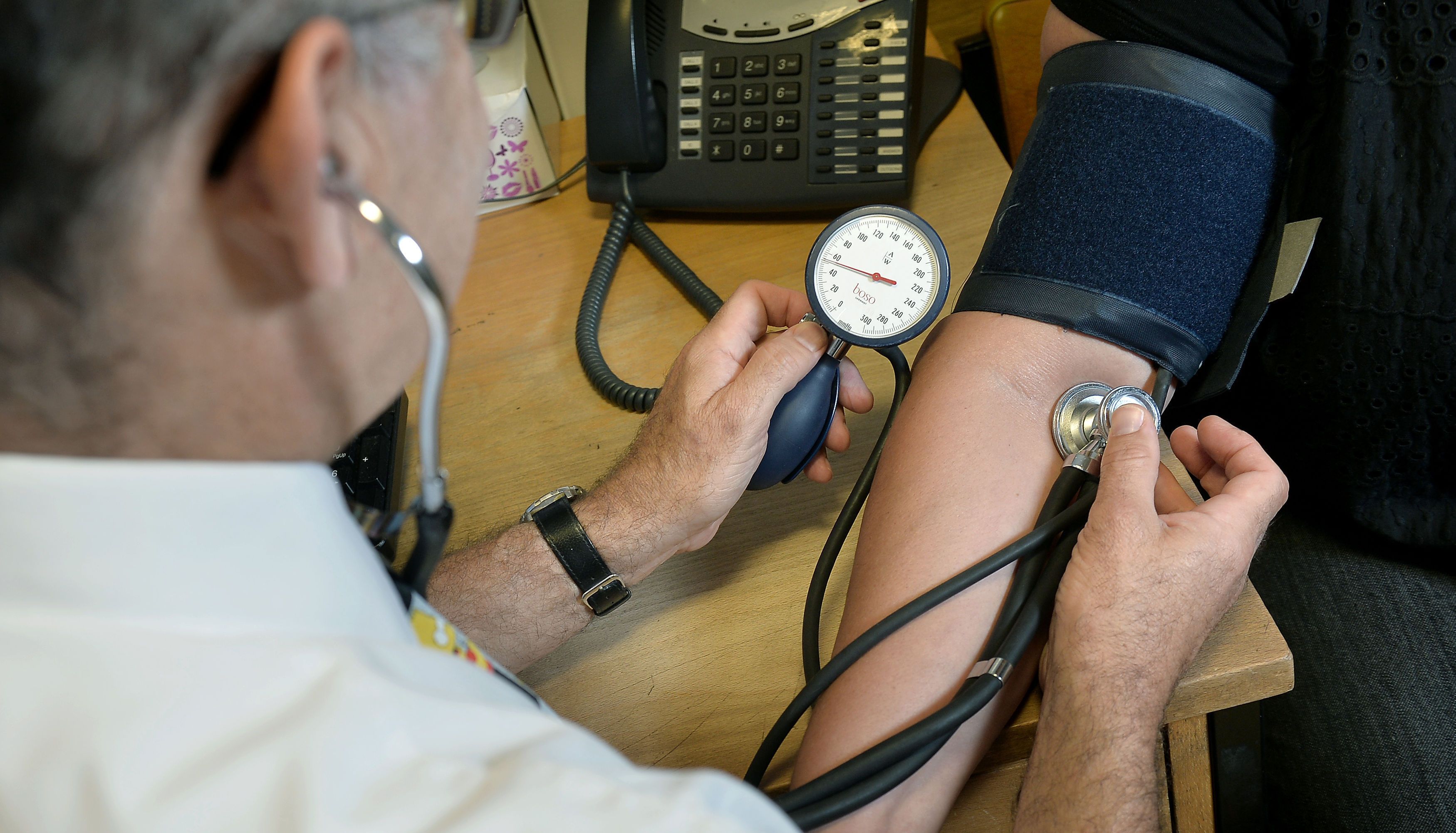File photo dated 10/09/14 of a GP using a stethoscope. GPs have threatened the possibility of industrial action over a contract that forces them to offer appointments at evenings and weekends. Issue date: Tuesday June 28, 2022.