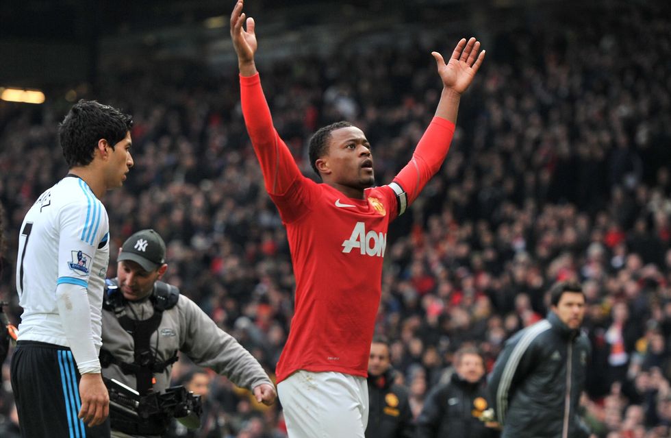 File photo dated 11-02-2012 of Manchester United's Patrice Evra celebrates victory as Liverpool's Luis Suarez walks off during the Barclays Premier League match at Old Trafford, Manchester.