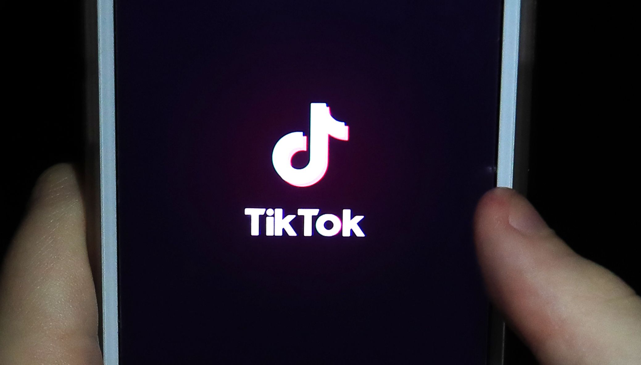 File photo dated 12/11/2019 of a young girl uses the TikTok app on a smartphone. TikTok could face a 27 million fine after the Information Commissioner's Office said it had found the company may have breached UK data protection law by failing to protect children's privacy when using the platform. Issue date: Monday September 26, 2022.