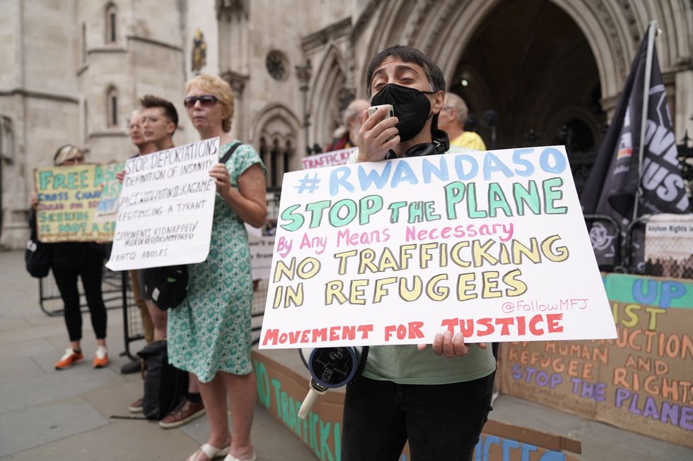File photo dated 13/06/22 of protesters outside the High Court in London. A High Court challenge against the Government's plan to deport some asylum seekers to Rwanda is set to begin. In April, Home Secretary Priti Patel signed what she described as a %22world first agreement%22 with Rwanda in a bid to deter migrants from crossing the Channel. However, the first deportation flight due to take off on June 14 was grounded amid a series of legal challenges. Issue date: Monday September 5, 2022.