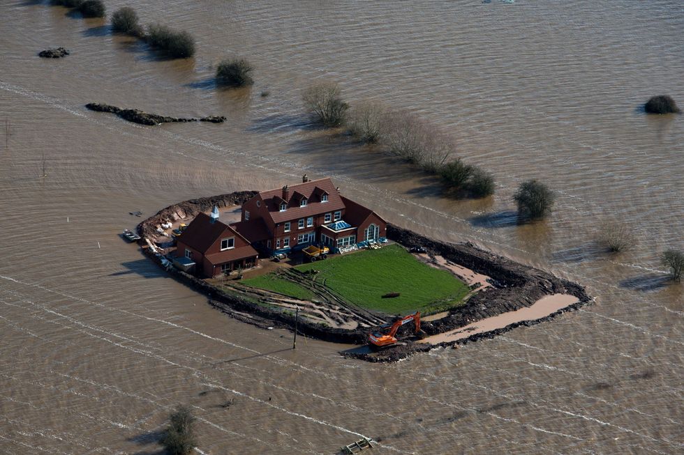 File photo dated 13/2/2014 of a house near flooded village of Moorland in Somerset. Issue date: Wednesday October 27, 2021.