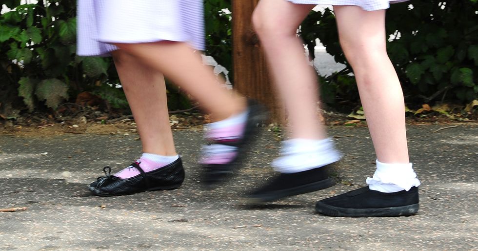 File photo dated 15/07/14 of school girls walking to school. The Government must %22begin reversing the family poverty crisis%22 by increasing child benefit and making changes to ensure children in larger families are not penalised, a new report warns. Issue date: Wednesday November 16, 2022.