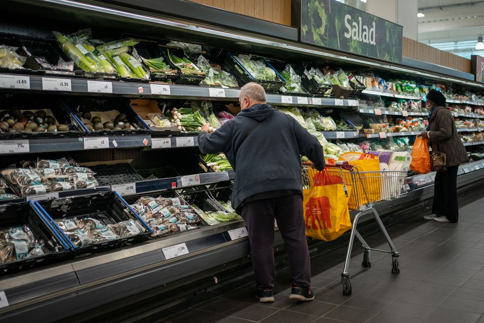 File photo dated 15/10/21 of shoppers in the fruit and vegetables section of a branch of Sainsbury's in London. The bosses of five of the UK's biggest supermarkets have promised to halve the environmental impact of a weekly food shop by the end of this decade, as leaders meet in Glasgow at a key climate change summit.
