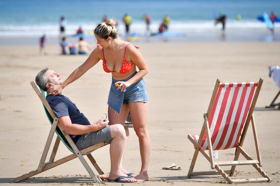 File photo dated 16/07/19 of sunbathers applying sunscreen during the hot sunshine on Towan beach in Newquay, Cornwall. Expensive mineral-based sunscreens have failed to provide the level of protection claimed on their packaging, according to consumer group Which? Issue date: Friday June 17, 2022.
