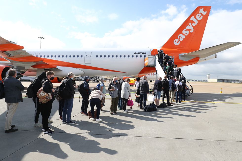 File photo dated 17/05/21 of passengers preparing to board an easyJet flight to Faro, Portugal, at Gatwick Airport in West Sussex. Issue date: Saturday September 18, 2021.
