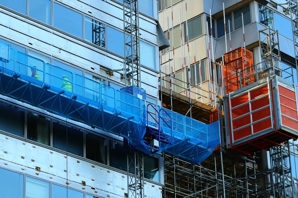 File photo dated 17/12/2020 of workmen remove the cladding from the facade of a block of flats in Paddington, north London. Ministers have been urged to go further in helping flat owners remove dangerous cladding after plans emerged to pressure developers to cover works costing up to 4 billion. In an apparent climbdown, Housing Secretary Michael Gove is expected to announce that leaseholders in buildings between 11 and 18 metres tall will no longer have to take out loans to cover the costs. Issue date: Saturday January 8, 2022.