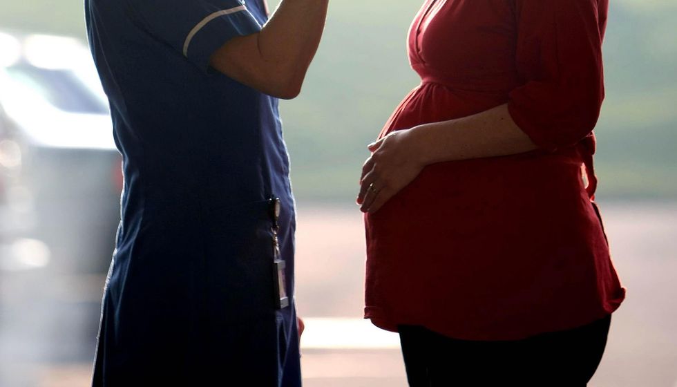 File photo dated 19/02/08 of a midwife talking to a pregnant woman. Midwives are being urged to vote in favour of taking industrial action over pay in a ballot launched on Friday. The Royal College of Midwives (RCM) started its second ballot on industrial action in England and its first in Wales in its 142-year history. Issue date: Friday November 11, 2022.