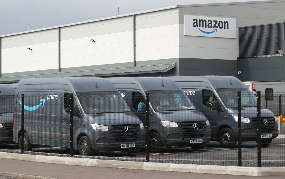 File photo dated 20/04/21 of electric delivery vans at the Amazon warehouse in the Titanic Quarter, Belfast, as the online retail titan is cutting more than 18,000 jobs worldwide in the largest layoffs programme in its history as part of plans to slash costs.