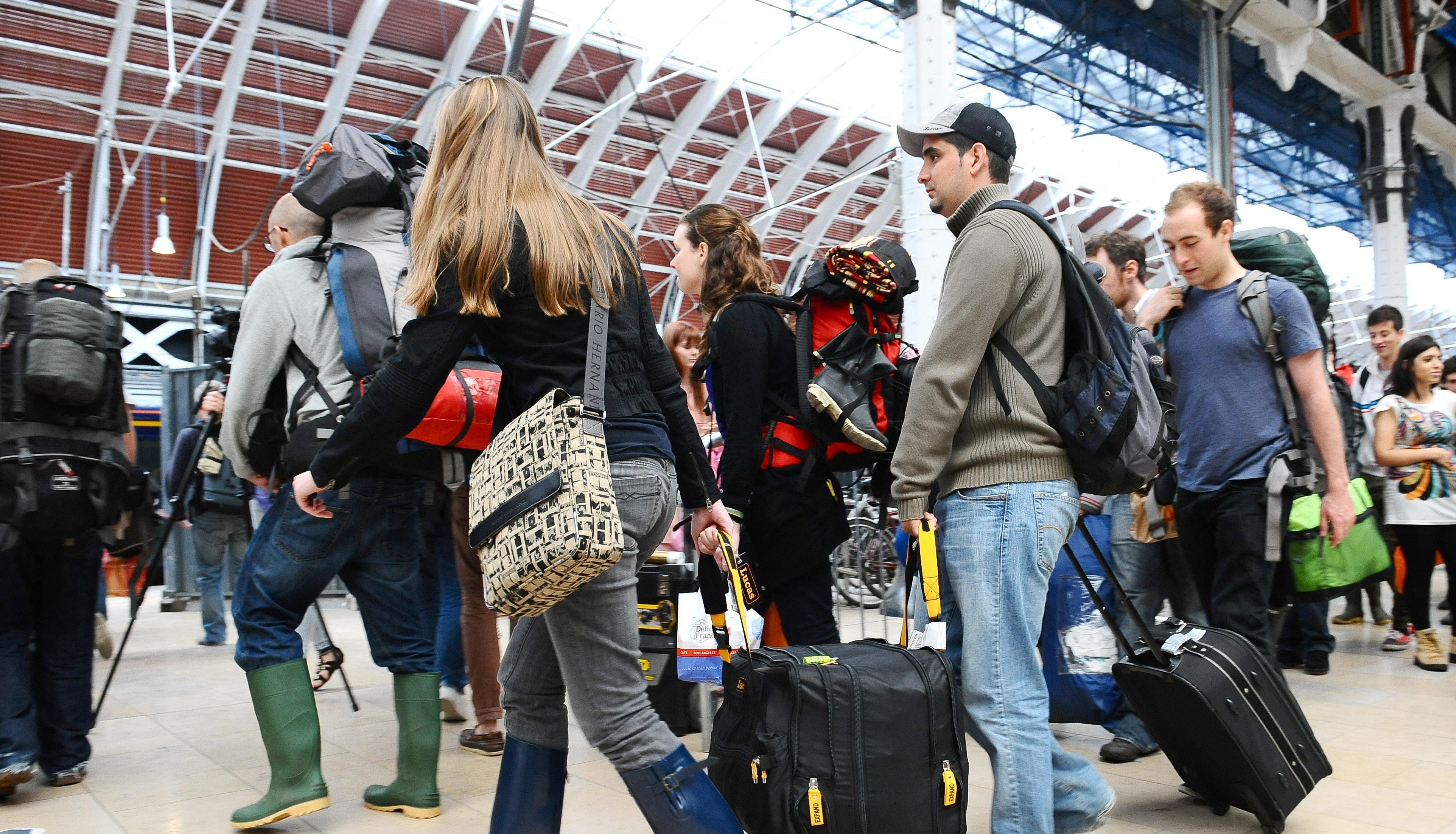 File photo dated 22/06/11 of music fans leaving Paddington Station in London, as they travel down to the Glastonbury Festival in Somerset. More than half of the trains due to serve the Glastonbury Festival have been cancelled because of rail strikes. Tens of thousands of revellers will be forced to find alternative routes to the site in Pilton, Somerset. Issue date: Monday June 20, 2022.