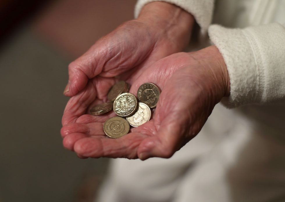 File photo dated 22/12/16 of an elderly woman holding pound coins in her hands, in Poole, Dorset. More than a third (36%) of savers say they are relying on their savings to get them through the cost-of-living crisis, according to the Building Societies Association (BSA). Issue date: Monday September 26, 2022.