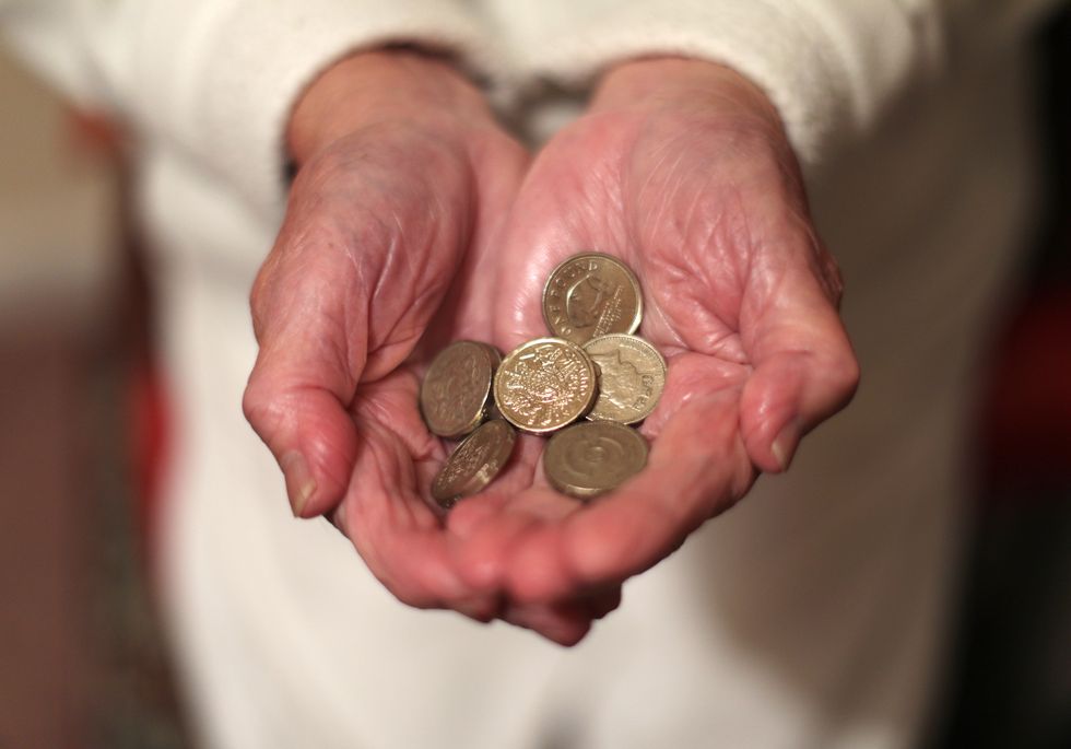 File photo dated 22/12/16 of an elderly woman holding pound coins in her hands, in Poole, Dorset. Pensioners on low incomes are being urged by Age UK to see if they qualify for Pension Credit, which could help them to access other cost-of-living support as well as topping up their regular income. Issue date: Wednesday December 7, 2022.