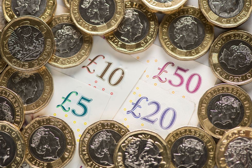 File photo dated 26/01/18 of UK five pound, ten pound, twenty pound and fifty pound notes with one pound coins. Scots have paid ??900 million more in tax in the past three years, but only ??170 million in net benefit has made its way to the government's budget, according to research from the Scottish Parliament Information Centre (Spice). Issue date: Friday August 13, 2021.