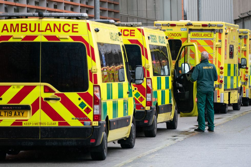 File photo dated 27\12\21 of a paramedic walking past a line of ambulances. An ambulance service is still asking patients suffering from suspected strokes or heart attacks to get relatives to drive them to hospital following pressures on staff due to coronavirus and new year demand.