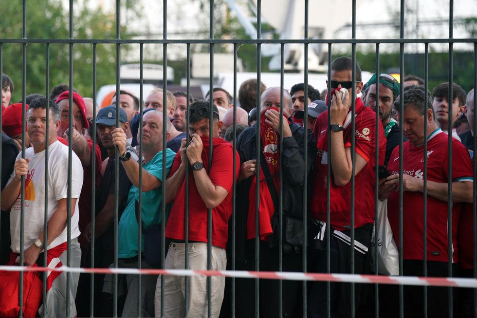 File photo dated 28-05-2022 of Liverpool fans cover their mouths and noses as they queue to gain entry to the stadium as Kick off is delayed ahead of the UEFA Champions League Final at the Stade de France, Paris. Liverpool have implored UEFA to fully implement all the recommendations made in the highly-critical independent report into the last years Champions League final chaos. Issue date: Tuesday February 14, 2023.