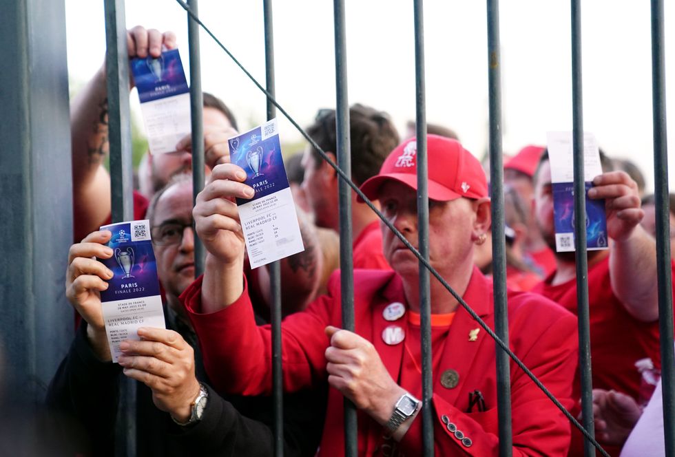 File photo dated 28-05-2022 of Liverpool fans stuck outside the ground show their match tickets during the UEFA Champions League Final at the Stade de France, Paris. Liverpool have implored UEFA to fully implement all the recommendations made in the highly-critical independent report into the last years Champions League final chaos. Issue date: Tuesday February 14, 2023.