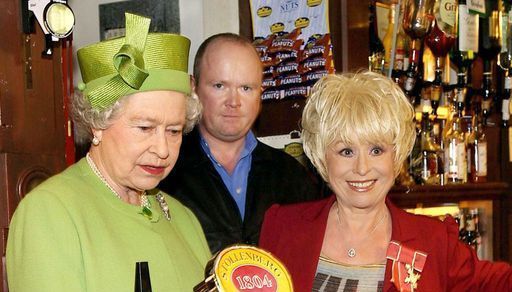 File photo dated 28/11/01 of Queen Elizabeth II (left) in the Queen Vic pub during a visit to Elstree Studios where EastEnders is filmed. She was accompanied by long standing cast member Barbara Windsor (Peggy Mitchell) and her on-screen son Steve McFadden (Phil Mitchell). Issue date: Sunday September 18, 2022.. Photo credit should read: Fiona Hanson/PA Wire