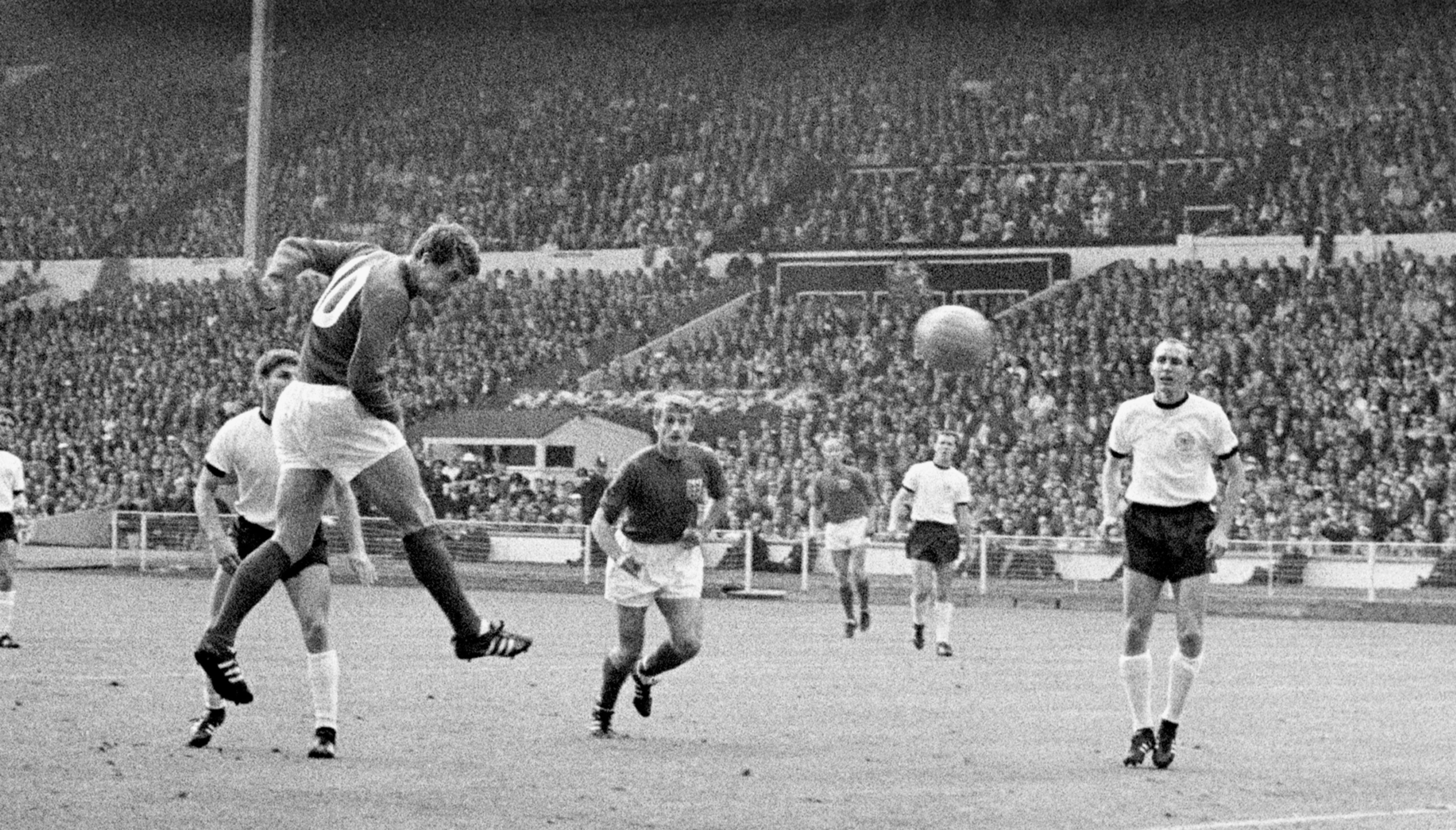 File photo dated 30-07-1966 of England's Geoff Hurst (second l) heads the equalising goal during the 1966 World Cup Final, watched by teammate Roger Hunt (c) and West Germany's Wolfgang Weber (l) and Willi Schulz (r). Sir Geoff Hurst, who scored a hat-trick when England won the World Cup final in 1966, tweeted: Proud of every single player and the way they have played. Issue date: Sunday December 18, 2022.