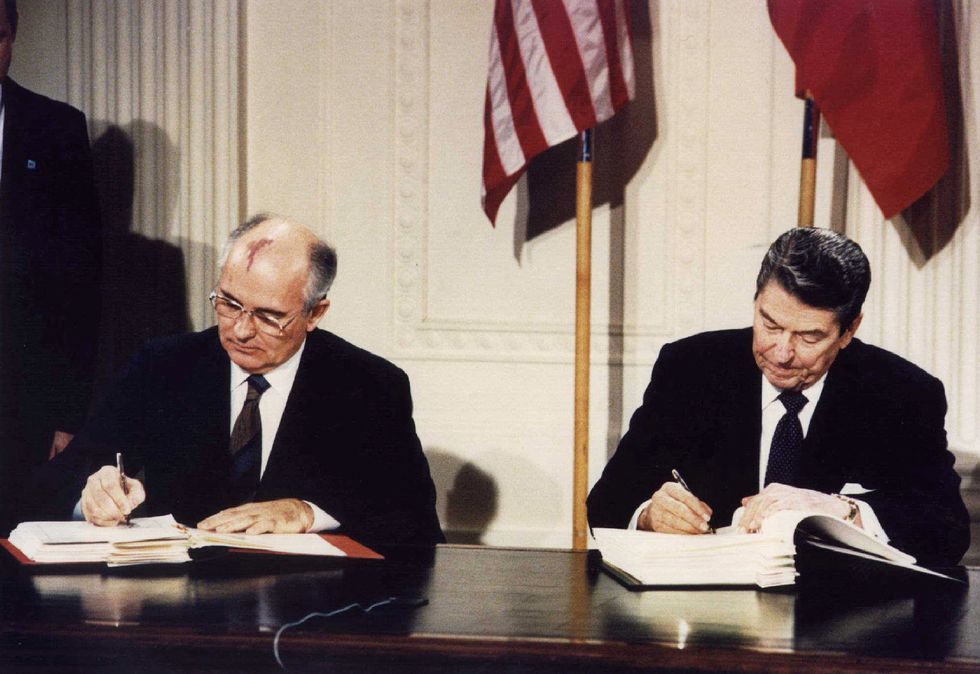 FILE PHOTO: File photo of U.S. President Ronald Reagan (R) and Soviet President Mikhail Gorbachev signing the Intermediate-Range Nuclear Forces (INF) treaty at the White House, Washington on December 8 1987. REUTERS/Dennis Paquin/File Photo