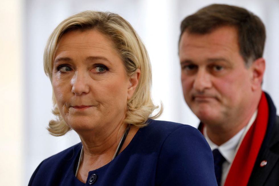 FILE PHOTO: French far-right National Rally (Rassemblement National) party leader Marine Le Pen and her companion Louis Aliot talk to journalists as they leave after a meeting with French Prime Minister as the %22yellow vest%22 nationwide protests continue, at the Hotel Matignon in Paris, France, December 3, 2018. REUTERS/Charles Platiau/File Photo
