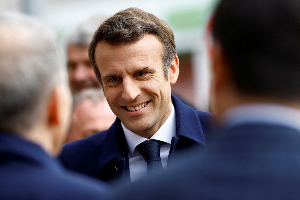 FILE PHOTO: French President Emmanuel Macron is welcomed by officials as he arrives for an election campaign appearance in Fouras, France, March 31, 2022. REUTERS/Stephane Mahe/File Photo