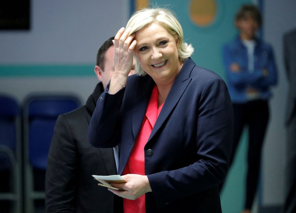 FILE PHOTO: Marine Le Pen, French National Front (FN) political party candidate for French 2017 presidential election, smiles before voting in the second round of 2017 French presidential election at a polling station in Henin-Beaumont, France, May 7, 2017. REUTERS/Charles Platiau/File Photo