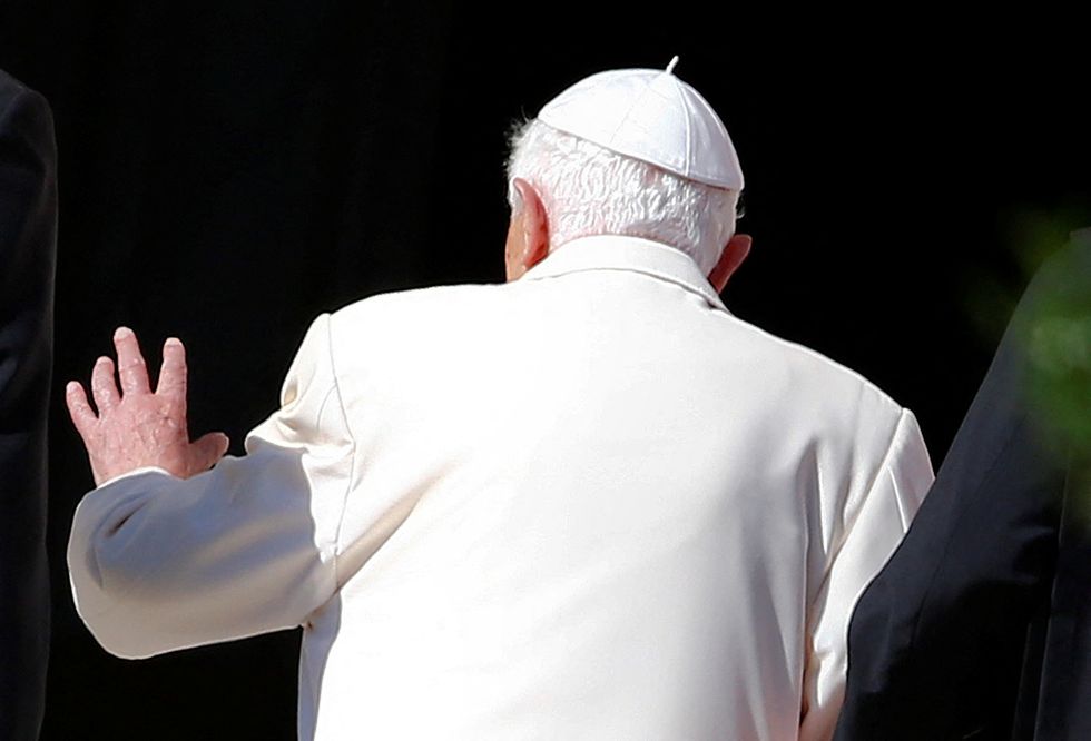 FILE PHOTO: Pope Emeritus Benedict XVI waves as he leaves after attending a gathering of elderly people in Saint Peter's square at the Vatican September 28, 2014. REUTERS/Tony Gentile/File Photo