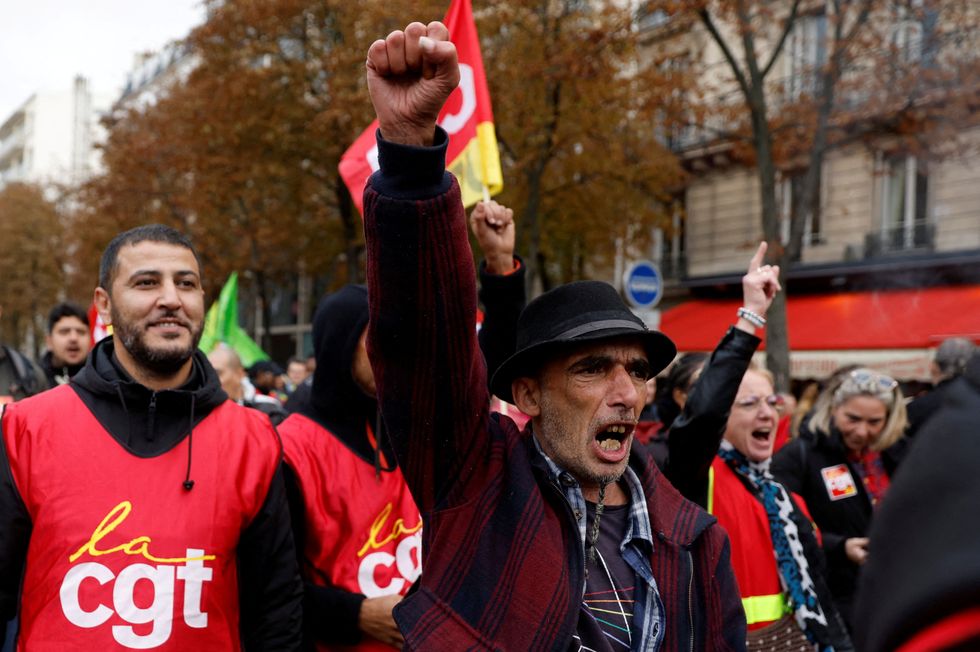 FILE PHOTO: Protestors and French CGT labour union workers attend a demonstration as part of a nationwide day of strike and protests to push for government measures to address inflation, workers' rights and pension reforms, in Paris, France, September 29, 2022. REUTERS/Gonzalo Fuentes/File Photo