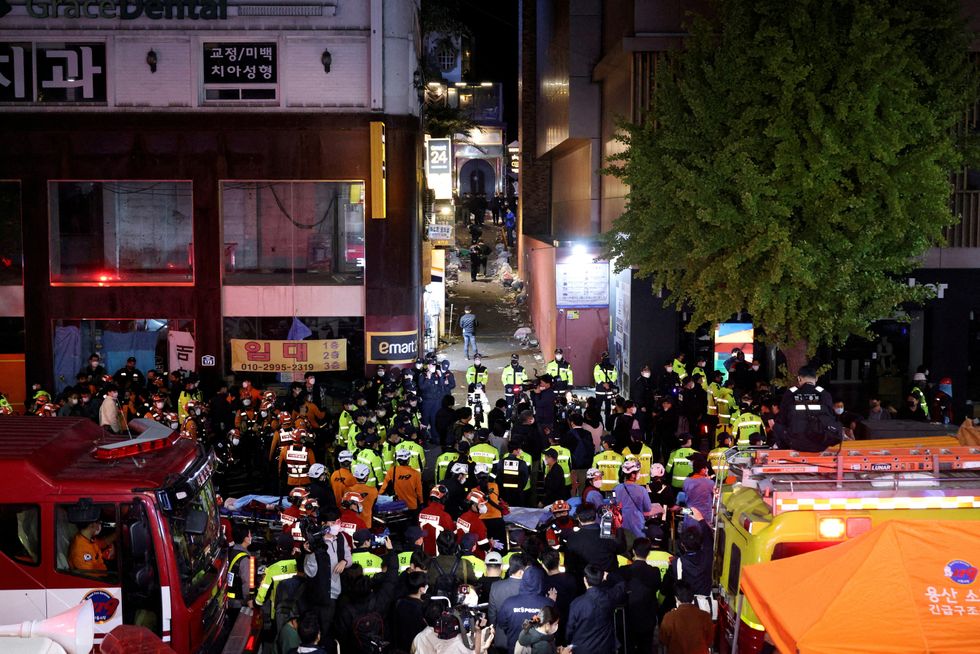FILE PHOTO: Rescue teams and firefighters work at the scene where people were killed and injured in a crush during Halloween festivities in Seoul, South Korea, October 30, 2022. REUTERS/Kim Hong-ji/File Photo