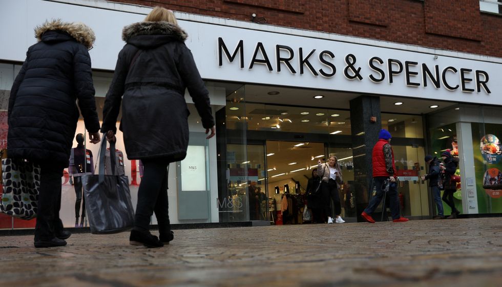 FILE PHOTO: Shoppers walk past a branch of Marks and Spencer in Altrincham, Britain January 7 2020. REUTERS/Phil Noble/File Photo