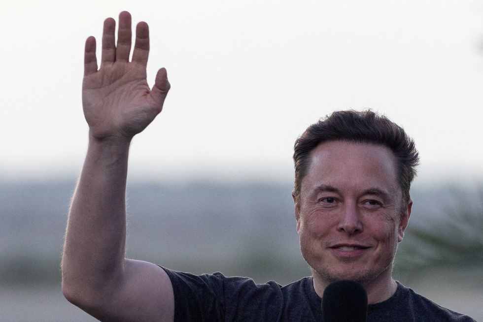 FILE PHOTO: SpaceX Chief Engineer Elon Musk waves during a joint news conference with T-Mobile CEO Mike Sievert (not pictured) at the SpaceX Starbase, in Brownsville, Texas, U.S., August 25, 2022. REUTERS/Adrees Latif/File Photo