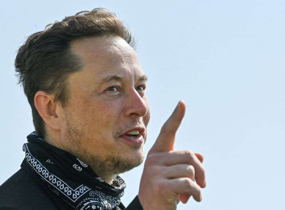 FILE PHOTO: Tesla CEO Elon Musk gestures as he visits the construction site of Tesla's Gigafactory in Gruenheide near Berlin, Germany, August 13, 2021. Patrick Pleul/Pool via Reuters - RC2B4P9PCFBM/File Photo