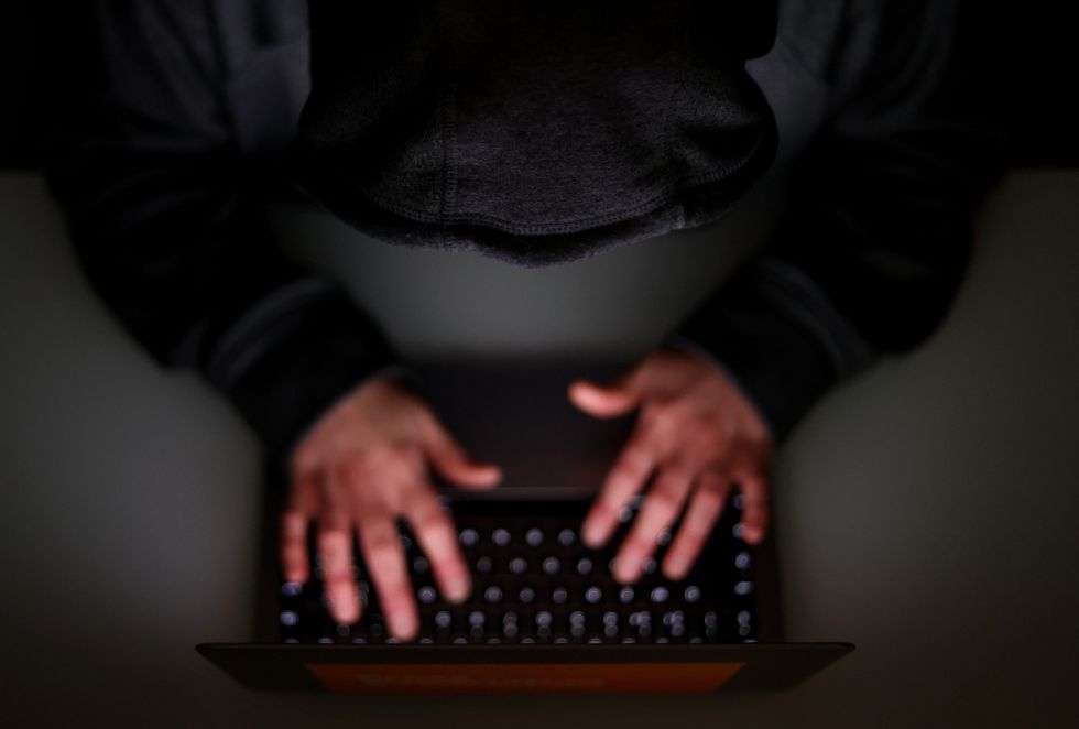 Fingers on laptop keyboard