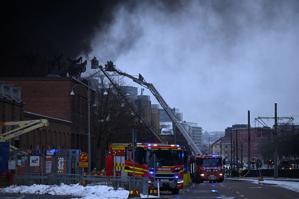 Fire engines by smoking building