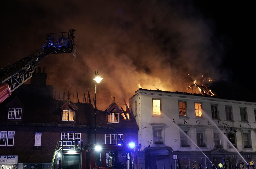 Fire fighters pouring water over hotel on fire