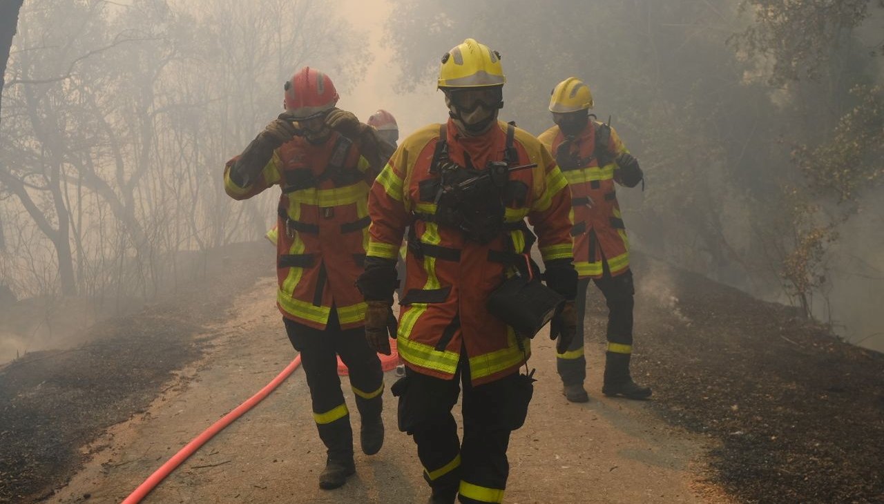 Fire fighters work to tackle a wildfire that broke out in the Var region, southern France.