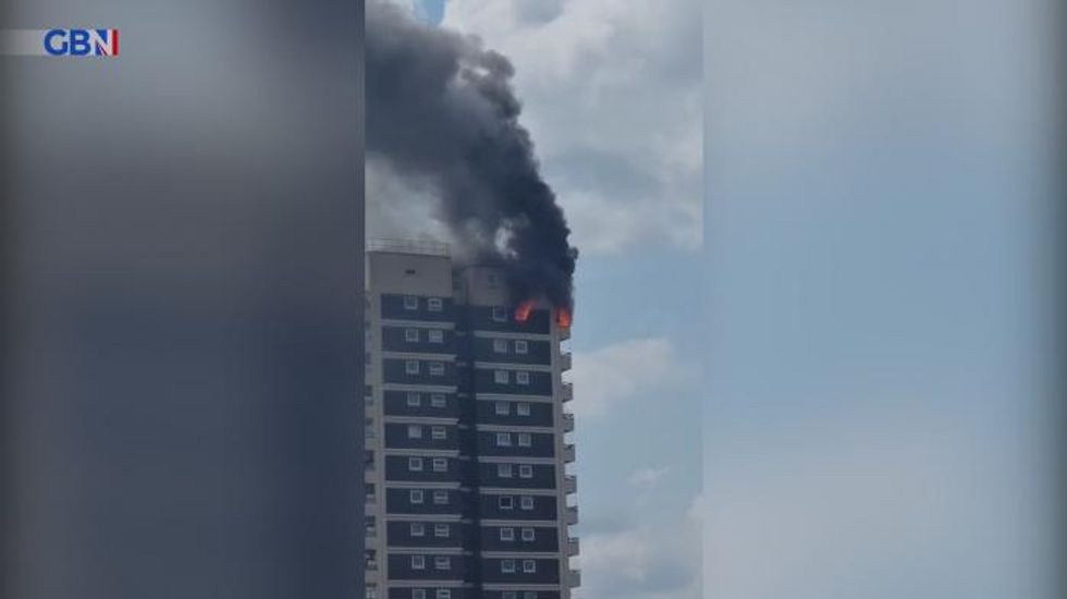 London flat in flames as 100 firefighters scramble to blaze at Docklands apartment block