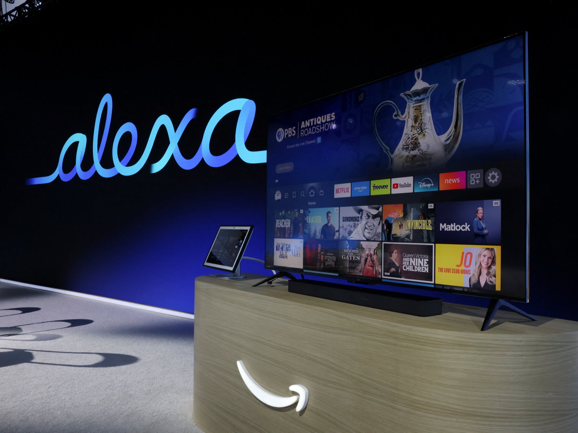 fire tv and echo show on-stage at the amazon event with the alexa logo in the background