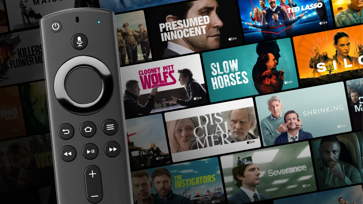 fire tv stick remote control on the left-side, with previews of some of the biggest apple tv plus films and shows in the background