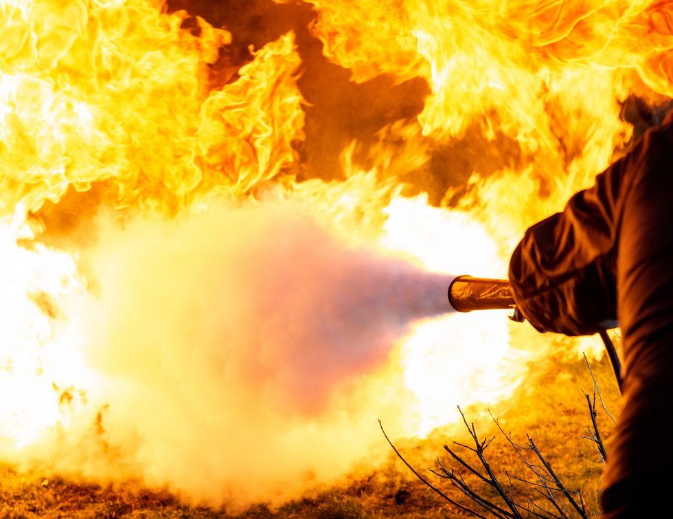Firefighter extinguishing fire