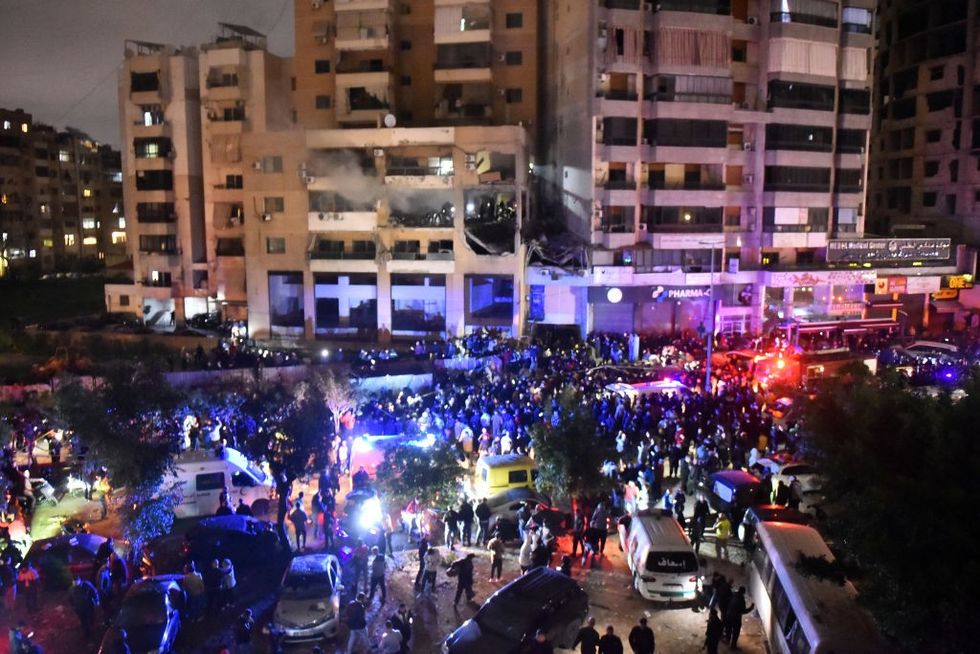 Firefighters and civil defense are seen in a damaged building that was allegedly targeted by an Israeli drone strike on January 2, 2024 in Dahiyeh, a suburb of Beirut, Lebanon