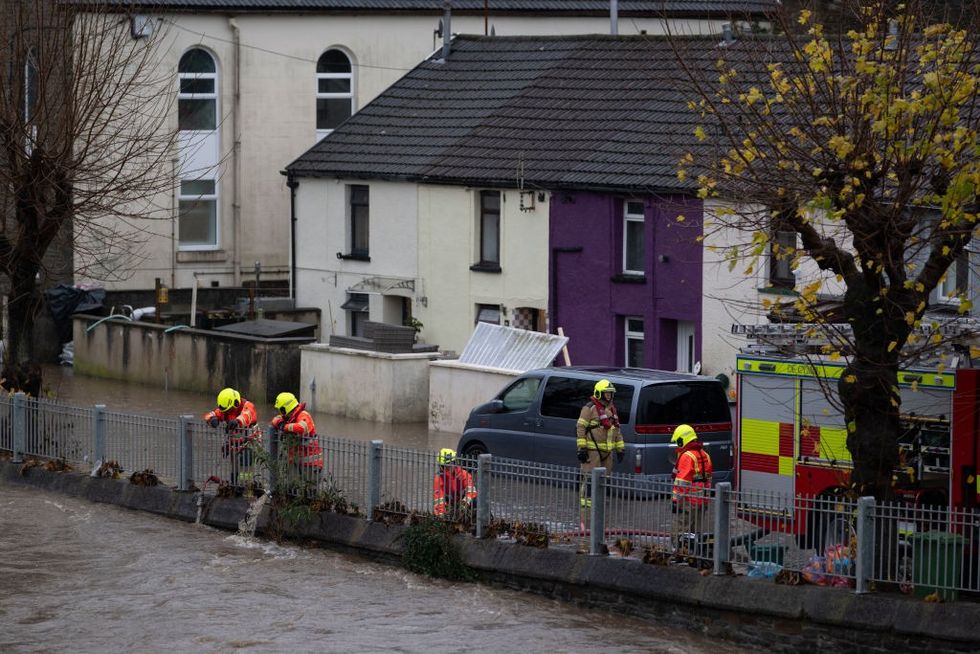 Firefighters pump water from Sion Street in Pontypridd