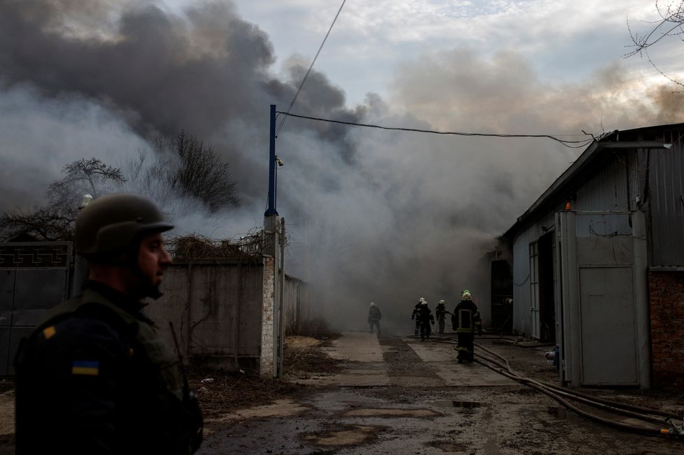 Firefighters try to contain a fire at a plant following Russian shelling, as Russia's attack on Ukraine continues, in Kharkiv, Ukraine, April 11, 2022. REUTERS/Alkis Konstantinidis
