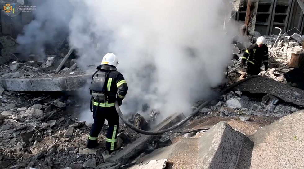 Firefighters work at the site of a Russian military strike, as the Russian invasion of Ukraine continues, in Mykolaiv, Ukraine, in this screengrab taken from a handout video released on July 15, 2022. State Emergency Service of Ukraine/Handout via REUTERS THIS IMAGE HAS BEEN SUPPLIED BY A THIRD PARTY. MANDATORY CREDIT.